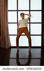 Handsome Young Guy Posing By The Window. Model Photographs In Home Interior. Glamor And Haute Couture.