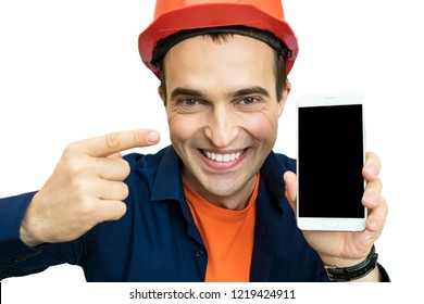 Handsome young guy with protective helmet on his head, shows white smart phone, background with copy space, advertising space, for recordings, to insert text or slogan