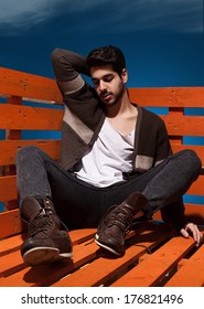 handsome young guy sitting and posing in casual clothes