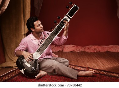 Handsome Young Indian Man Plays A Sitar