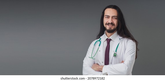 Handsome Young Italian Male Doctor Portrait Studio Shot Includes Copy Space. He Is In Confident Mood.