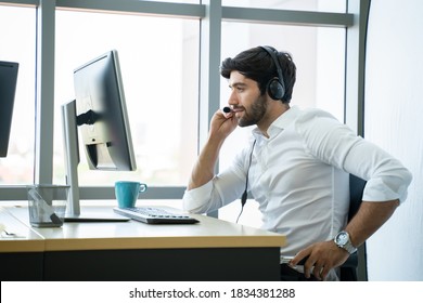 Handsome Young Male Call Centre Operator With Headset.Confident Male Customer Service Representative,operator,agent,call Centre Worker,support Staff Speaking With Head Set In Modern Office