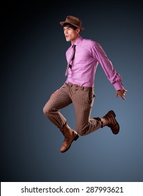 handsome young male model jumping - clean studio shoot, copy space