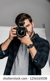 Handsome Young Male Photographer Shooting With Professional Camera 