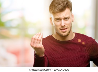 Handsome Young Man Angry Gesturing Typical Italian Gesture With Hand, Looking To Camera