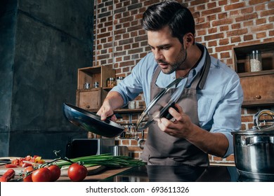 Handsome Young Man With Apron Cooking