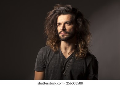 handsome young man with a beard and long hair