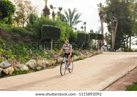 Similar – Image, Stock Photo Young man with bicycle in the sea