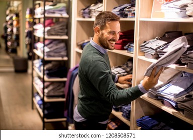 Handsome Young Man Buying Clothes In The Store