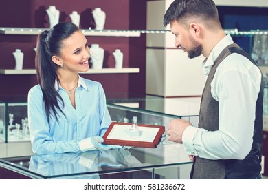 Handsome Young Man Buying Jewelry At The Local Jewelry Store