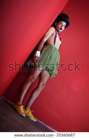 Handsome young man in corner wearing surreal clothing