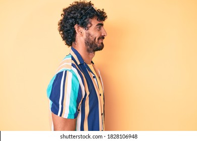 Handsome Young Man With Curly Hair And Bear Wearing Summer Shirt And Sunglasses Looking To Side, Relax Profile Pose With Natural Face With Confident Smile. 