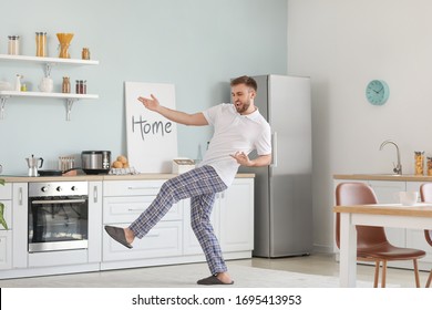 Handsome Young Man Dancing In Kitchen