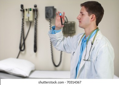 A Handsome Young Man Doctor Holding A Test Tube Vial Sample Of Blood