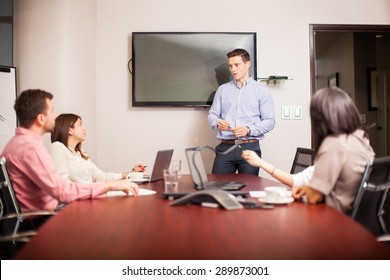 Handsome Young Man Dressed Casually And Giving A Sales Pitch In A Meeting Room