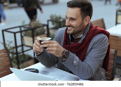 Handsome Young Man Drinking Coffee At The Coffeehouse