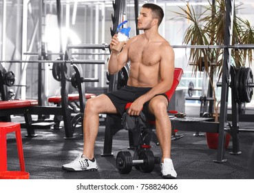 Handsome Young Man Drinking Protein Shake In Gym