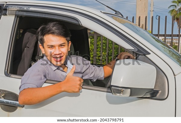 handsome young man\
driving a private car