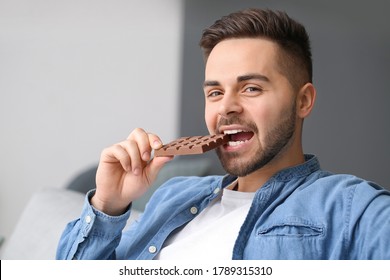 handsome-young-man-eating-chocolate-260nw-1789315310.jpg