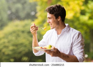 Handsome Young Man Eating Scrambled Egg For Breakfast