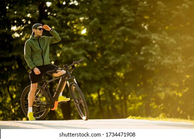 Handsome Young Man With Ebike, Mountain Bike With Electric Battery In The Park