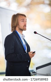 Handsome Young Man Giving A Speech At A Conference