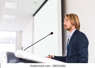 Handsome Young Man Giving A Speech At A Conference