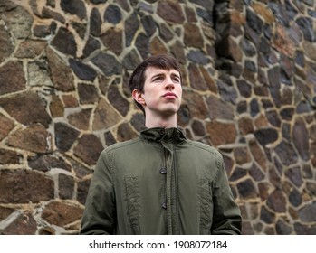 A handsome young man in his late teens or early twenties looking into the distance with a strong optimistic expression. - Shutterstock ID 1908072184