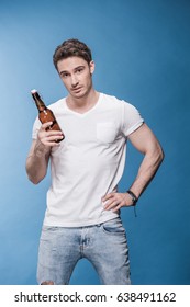 Handsome Young Man Holding Beer Bottle And Looking At Camera 