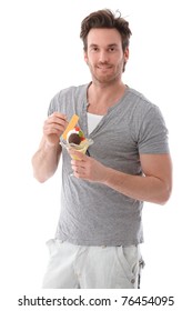 Handsome Young Man Holding Ice Cream Cup Smiling.