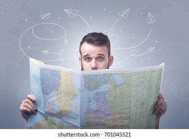 Handsome Young Man Holding A Map With Drawn Paper Planes Flying Behind Him 