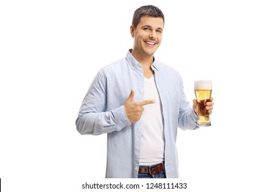 Handsome Young Man Holding A Pint Of Beer And Pointing At It Isolated On White Background