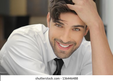 Handsome Young Man Leaning On His Hand With Nice Big Real Smile