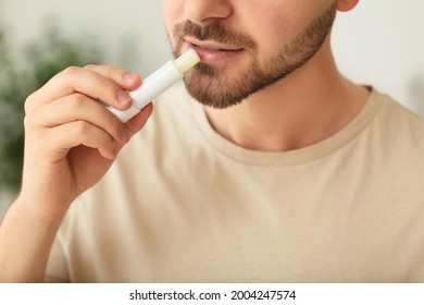 Handsome Young Man With Lip Balm At Home, Closeup