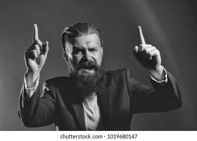 Handsome young man with long beard and moustache on smiling happy in black jacket with raised finger in studio on grey background - Shutterstock ID 1019680147