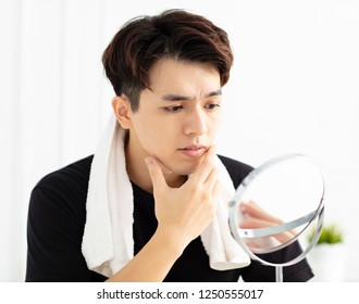 Handsome Young Man Looking In Mirror