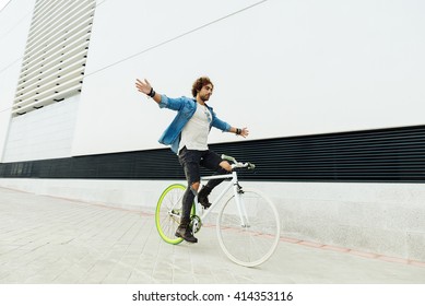 Handsome Young Man On Bike Without Hands In The City. Bicycle Concept