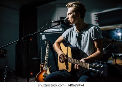 Handsome Young Man On Rehearsal Base. Lyric Singer With Acoustic Guitar.