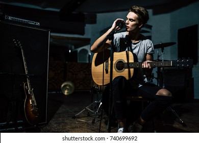 Handsome Young Man On Rehearsal Base. Lyric Singer With Acoustic Guitar.