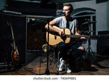 Handsome Young Man On Rehearsal Base. Lyric Singer With Acoustic Guitar.