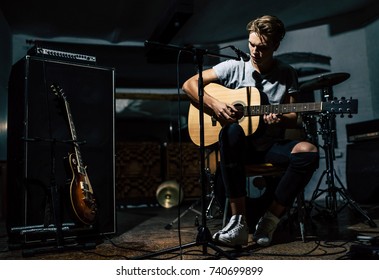 Handsome Young Man On Rehearsal Base. Lyric Singer With Acoustic Guitar.