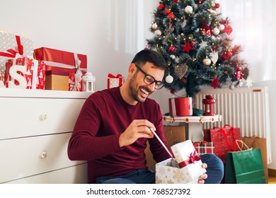 Handsome Young Man Opening His Christmas Gift