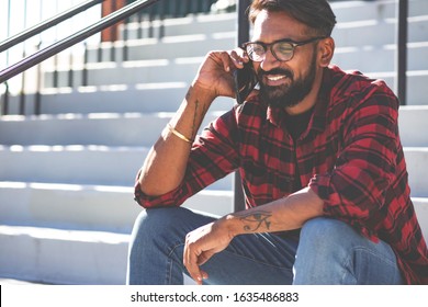 Handsome Young Man, Outdoor.
Indian Man Is Talking On A Cell Phone.