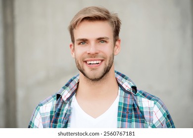 Handsome young man outdoor. Millennial man wearing checkered shirt. Casual style of millennial man. Portrait of man in casual style shirt. Stylish face portrait of cheerful unshaven guy - Powered by Shutterstock