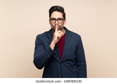 Handsome young man over isolated background showing a sign of silence gesture putting finger in mouth