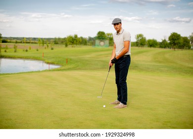 Handsome young man playing golf
