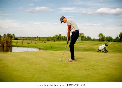 Handsome young man playing golf - Powered by Shutterstock