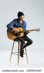 Handsome Young Man Playing Guitar On White Background