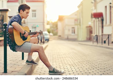 Handsome Young Man Playing Guitar