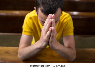 Handsome Young Man Praying In A Church